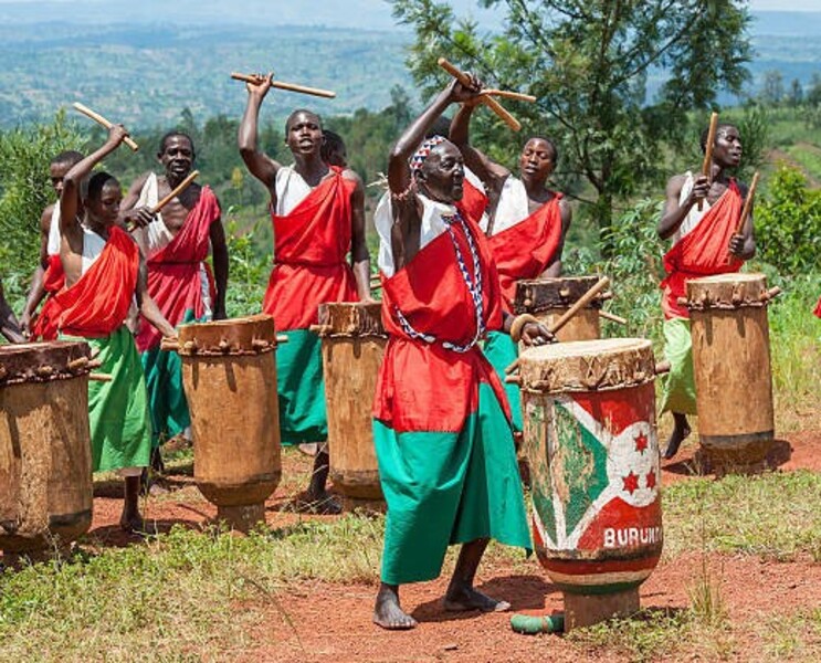 Gitega, Burundi - December 30, 2010: Close up shot of a drummers who are performing in a traditional local show - they are members of the famous drummers and Dancers of Gitega in Burundi, Africa. Drumming and dancing is an important part of Burundian cultural heritage and is frequently perfomed at official ceremonies and rituals. The typical drums are made locally in Northern Burundi.